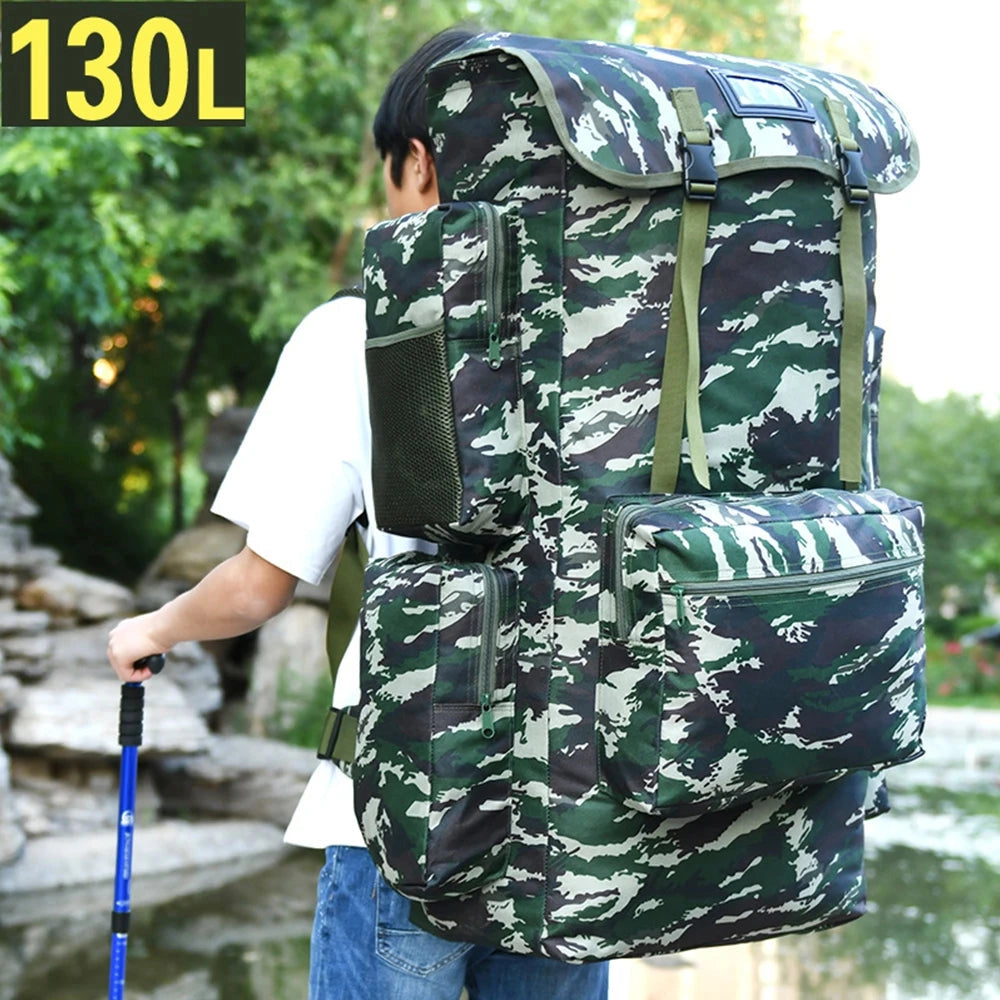 Olive military backpack with a large 130L capacity designed for travel, featuring durable materials and multiple compartments, displayed on grassy terrain.