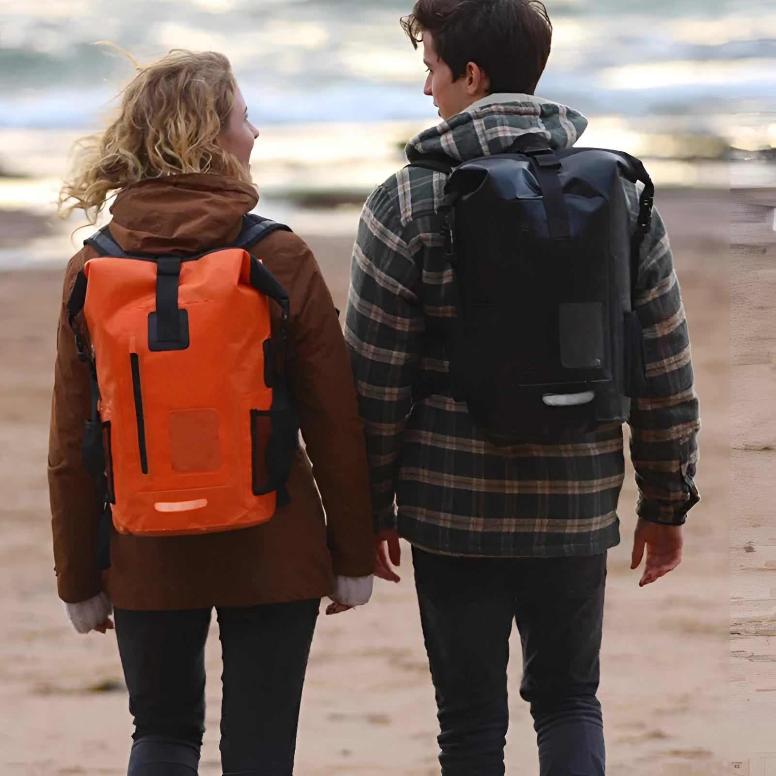 
A person standing outdoors wearing a durable 35L waterproof dry bag backpack, designed for travel and adventure, with a tartan pattern in the background. The person appears happy and is dressed in casual outdoor attire.