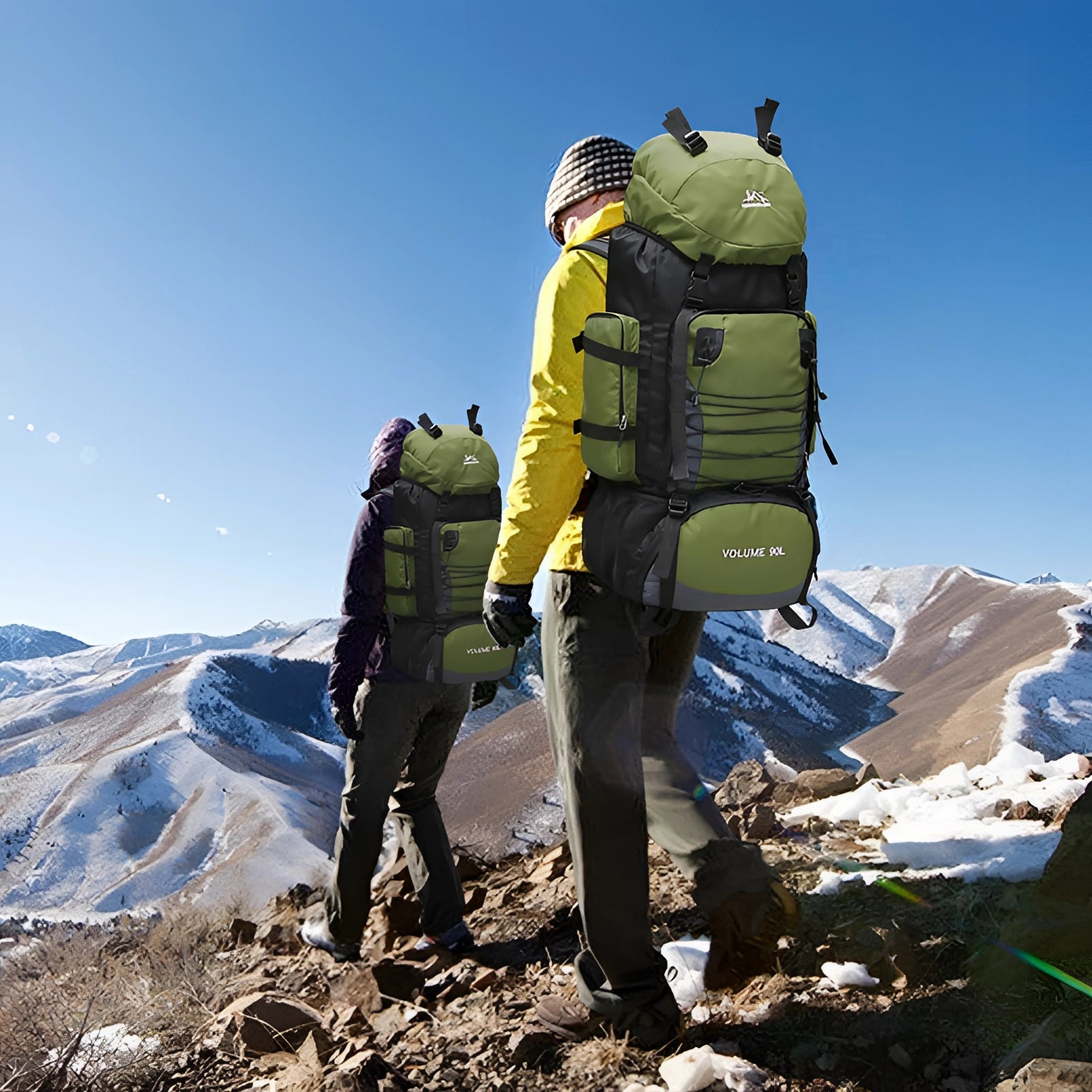 90L large-capacity hiking backpack in use by a group of hikers walking on a snow-covered mountain slope under a clear sky, showcasing its durability and suitability for outdoor travel and outdoor recreation.