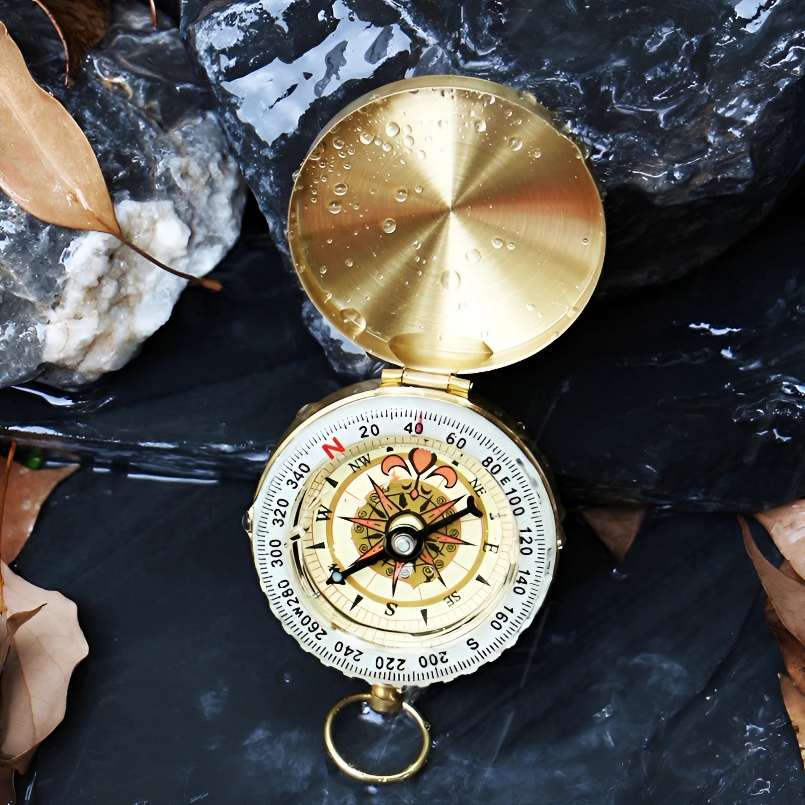 Antique brass pocket compass with a vintage glow-in-the-dark feature, metal casing, circular design, and intricate details, ideal for outdoor navigation.