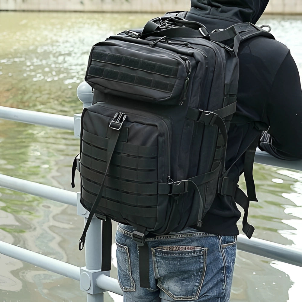 Black tactical backpack with MOLLE system, water-resistant, 45L capacity, multi-compartment design.