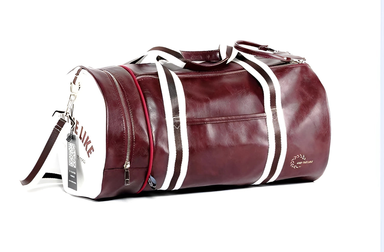 Burgundy leather duffel bag with elegant design, featuring sturdy handles and metal accents, suitable for men's travel and gym use.