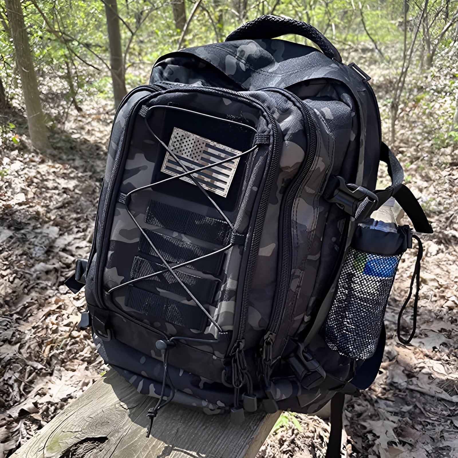 Camouflage military-grade tactical backpack, water-resistant with MOLLE system and hydration-ready, displayed outdoors on grass.