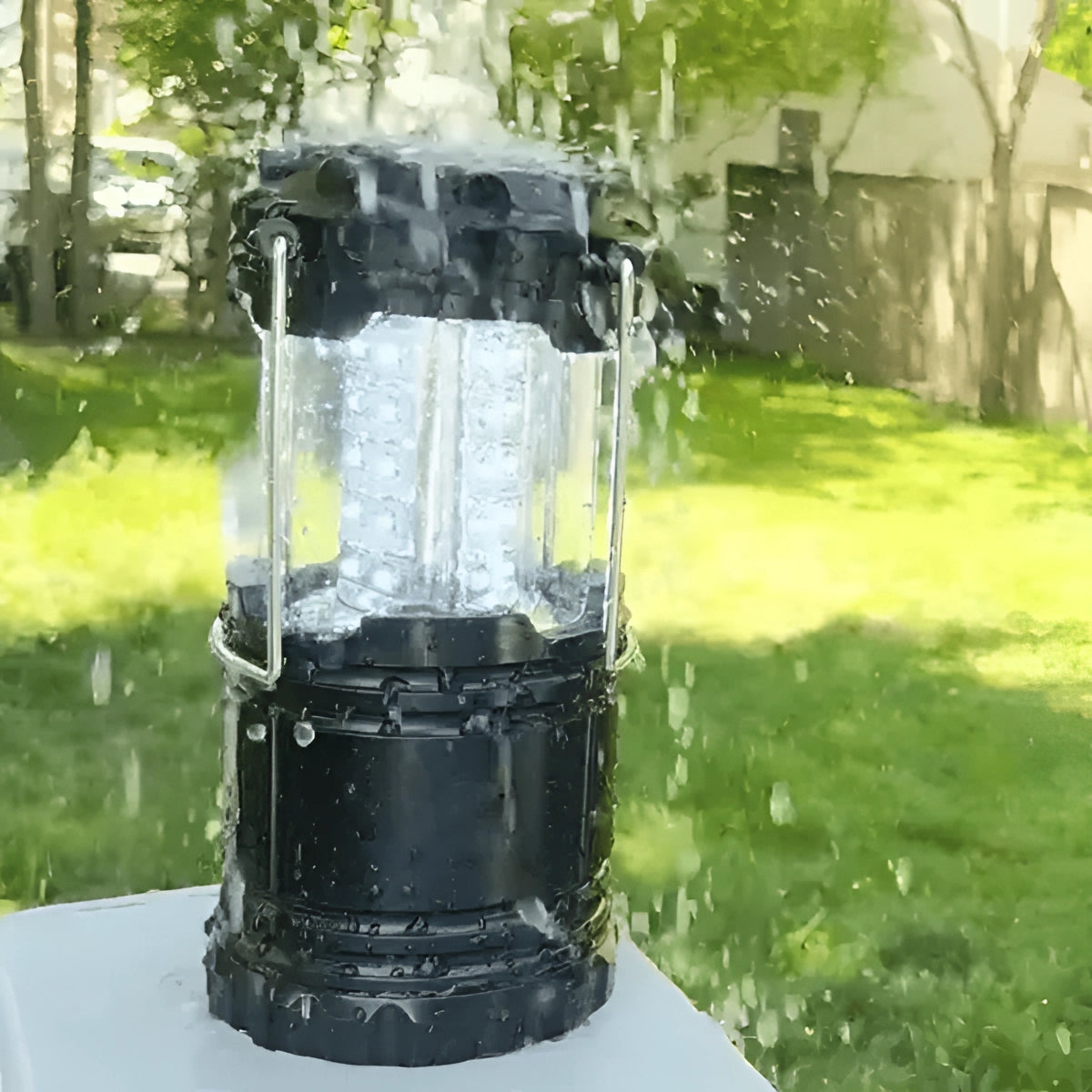 Dual-Function LED Camping Lantern & Rechargeable Flashlight - Waterproof, shown outdoors near a water feature with grass and plants in the background.