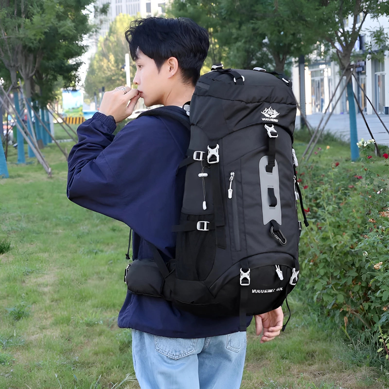 Durable 60L waterproof hiking backpack in electric blue, designed for travel and outdoor adventures, shown in a natural setting with trees.