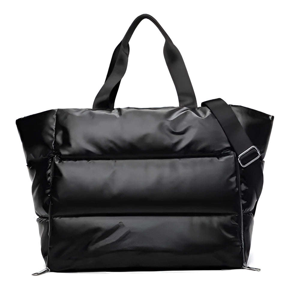 A large black quilted satin tote bag with a fashionable design, features a spacious interior, sturdy straps, and a sleek rectangular shape.