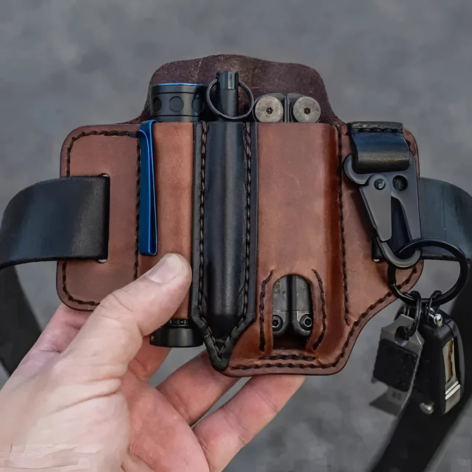 Hand holding a digital camera equipped with a handcrafted leather camera strap and adjustable harness, showcasing professional gear and camera accessory.