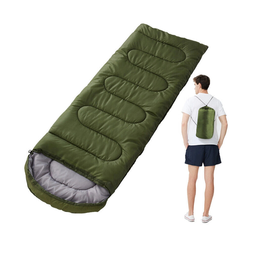 Army Green Lightweight All-Season Water-Resistant Camping Sleeping Bag laid out on grass with a focus on the bag's comfort and durability.