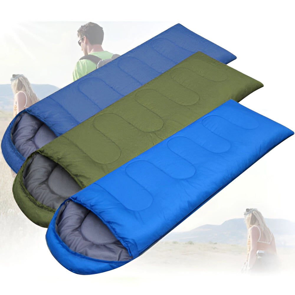 Lightweight all-season water-resistant camping sleeping bag in electric blue color, displayed outdoors on green grass next to a tent.