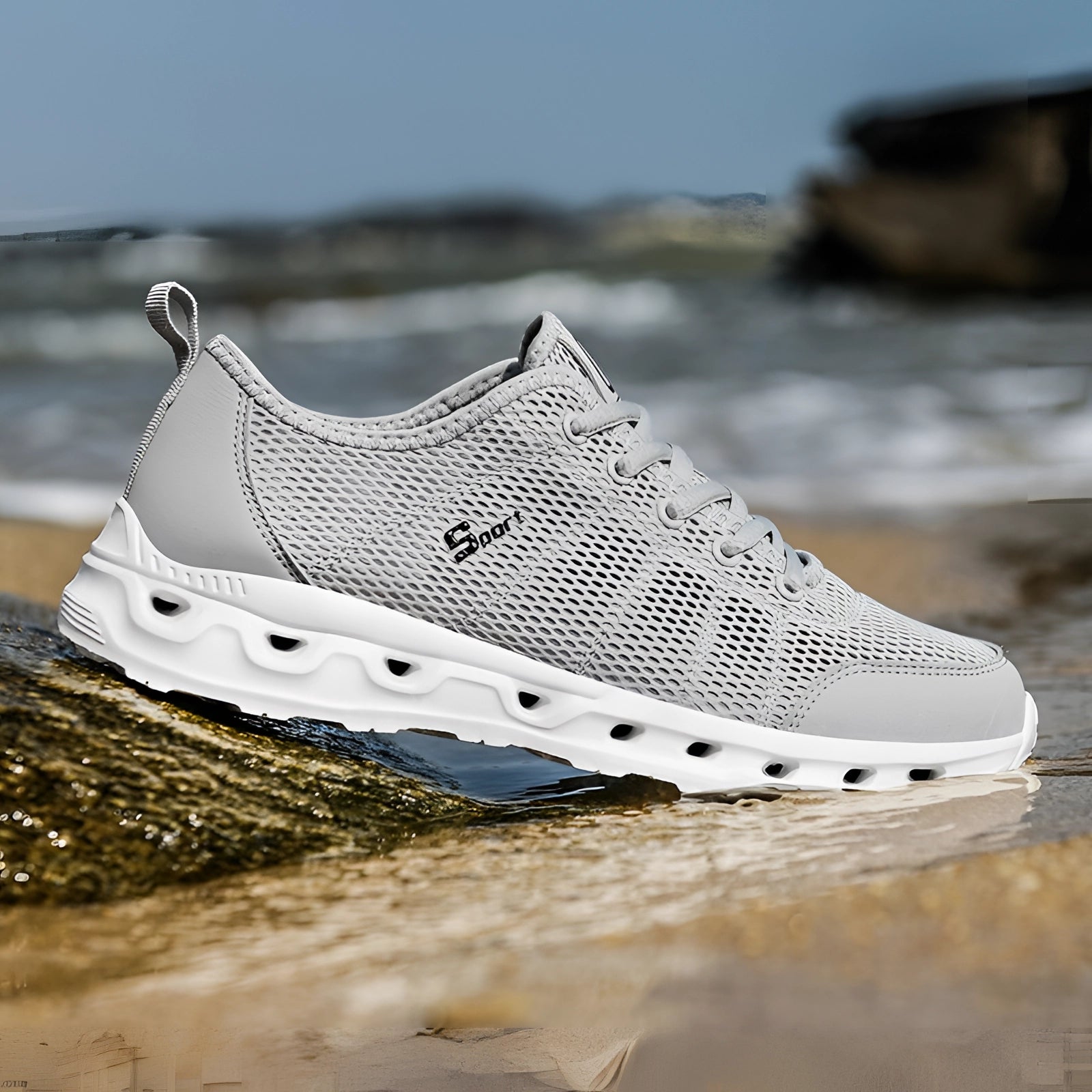 Lightweight breathable mesh running shoes in gray, size 12, with cushioned and durable design, displayed against a natural outdoor background.