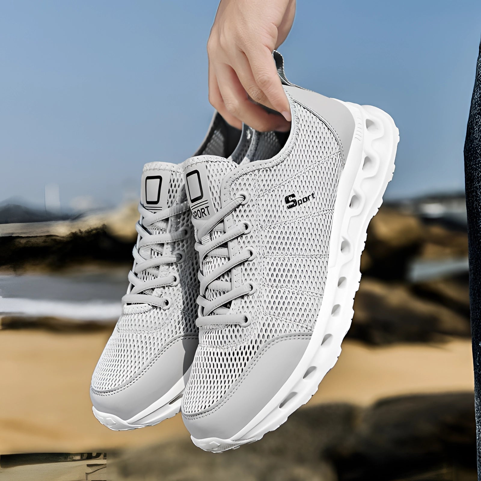 Black and white lightweight breathable mesh running shoes with cushioning, shown outdoors on a human leg.