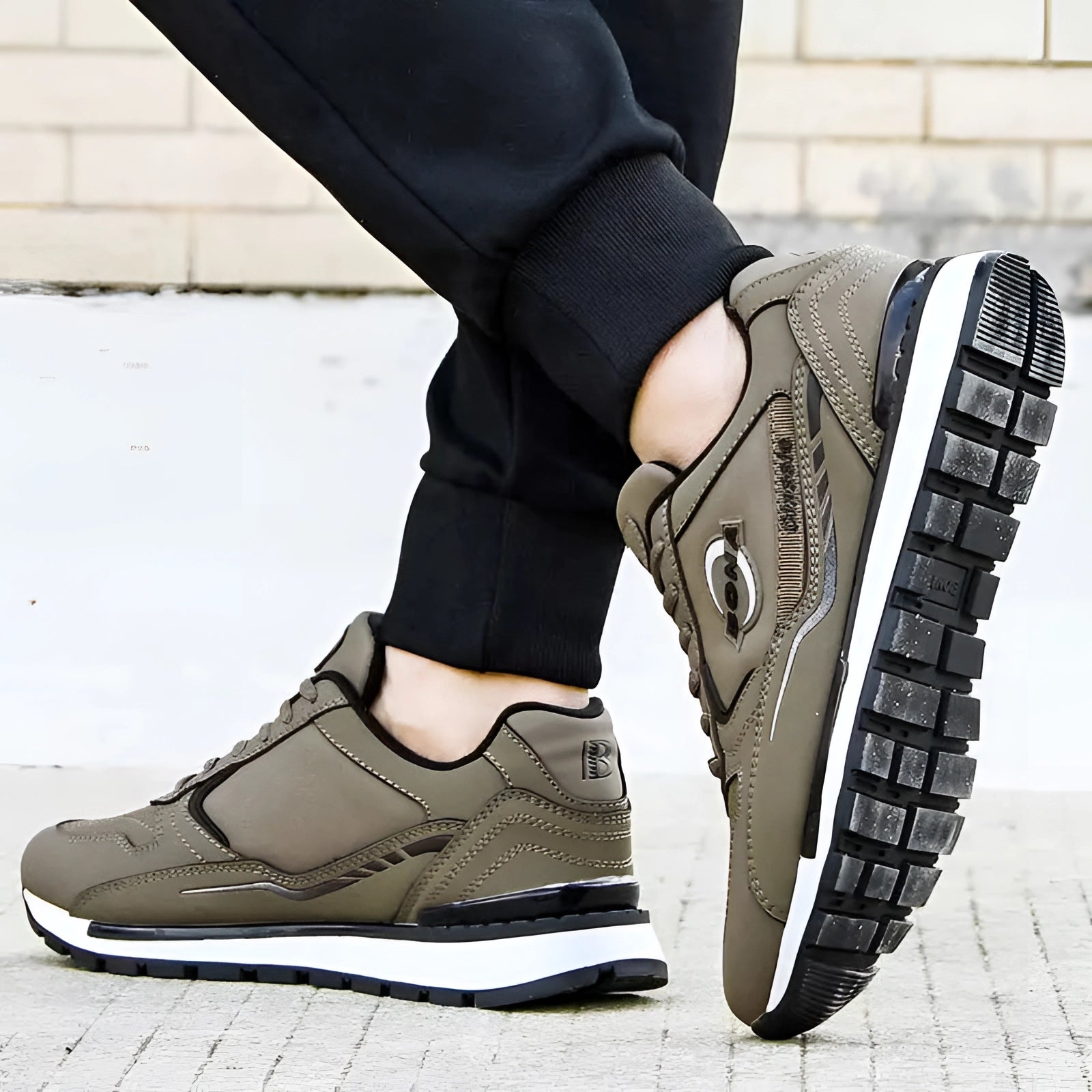 Men's beige running sneakers, comfortable low-top athletic shoes, shown on a person's feet, highlighting the footwear's stylish design suitable for sportswear and casual wear.