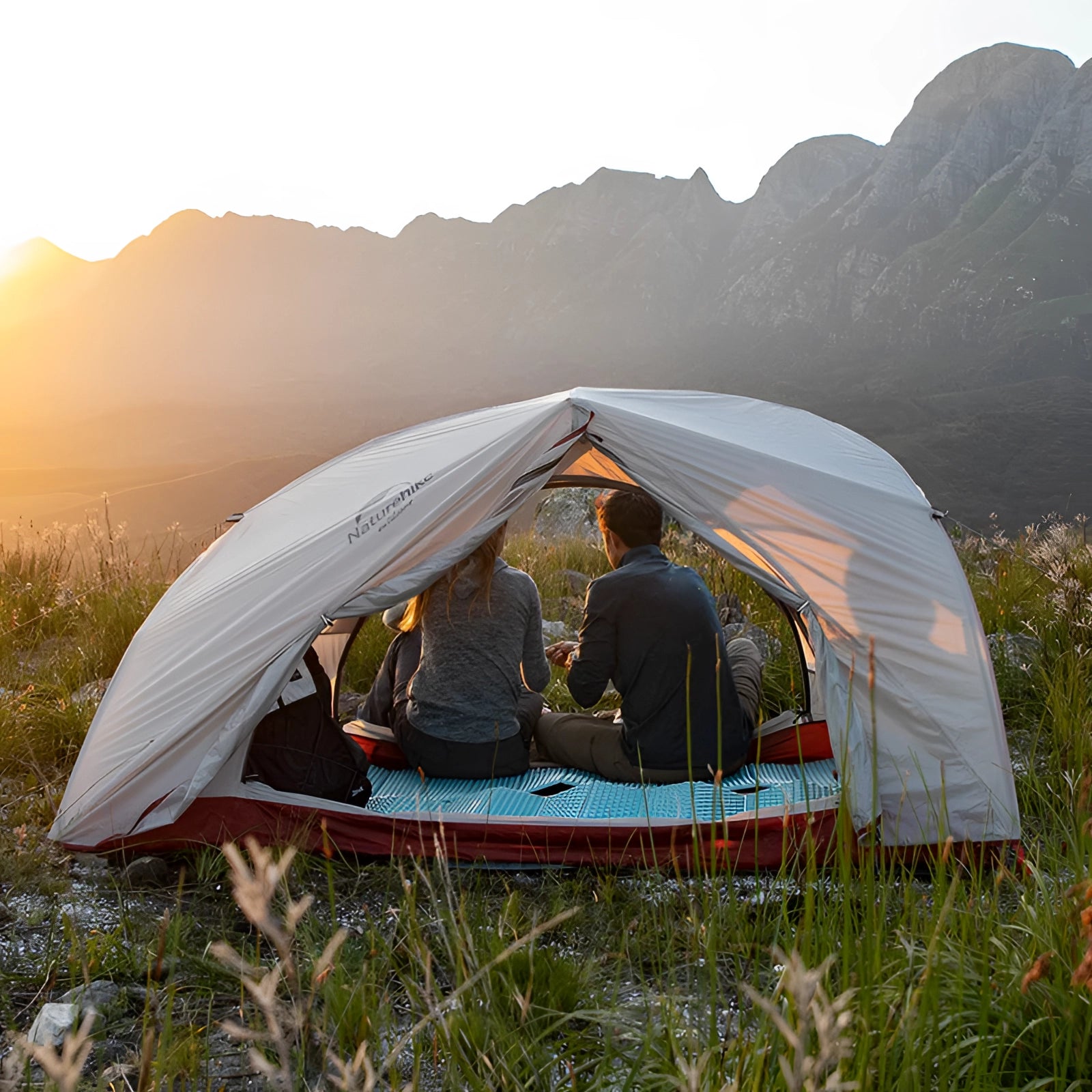 Naturehike Cloud-Up Ultralight Waterproof 2-Person Tent set up in a grassy area with mountains in the background under a clear sky.