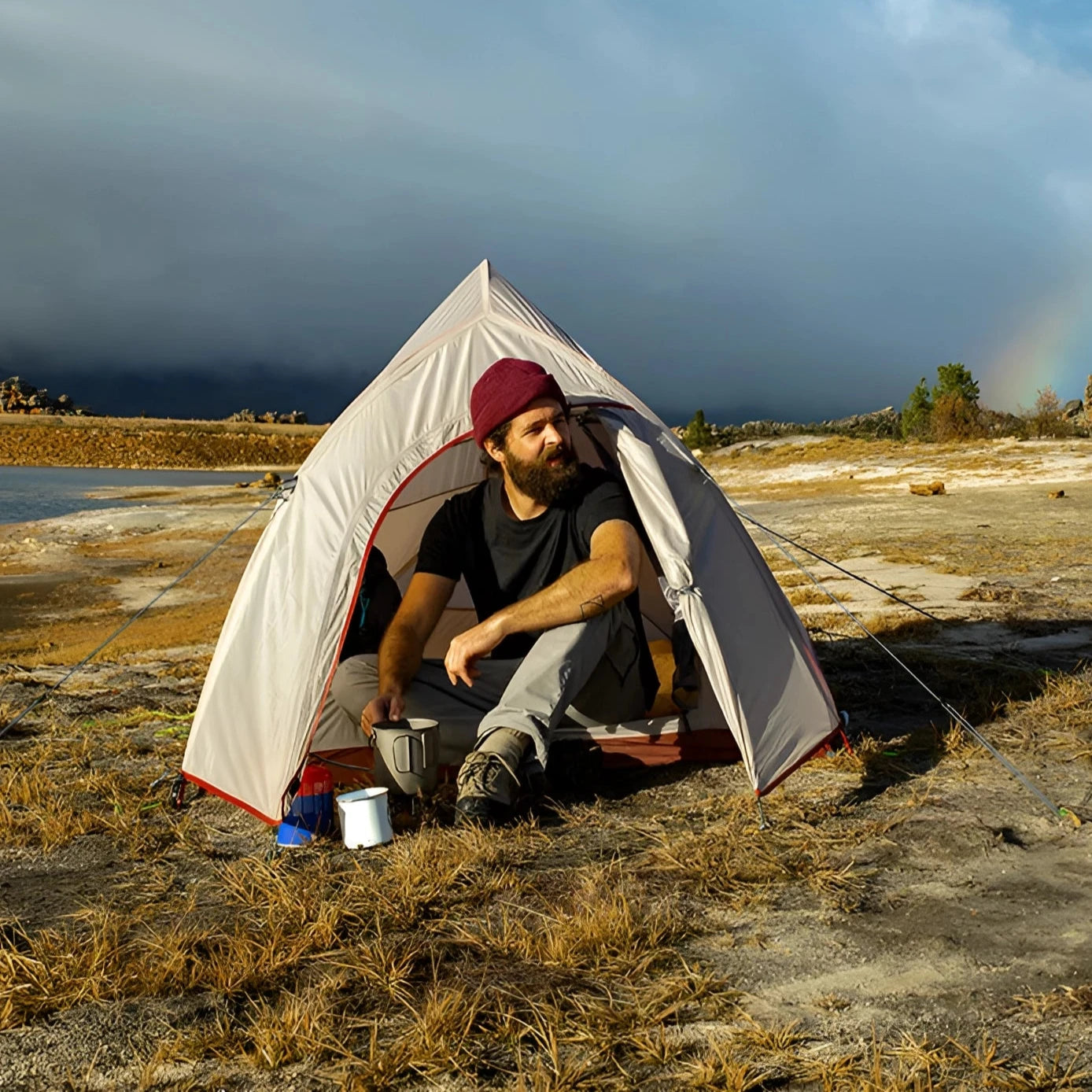 A Naturehike Cloud-Up Ultralight 2-Person Waterproof Tent set up in a grassy plain under a clear sky with clouds, surrounded by a natural landscape, perfect for camping and outdoor recreation.