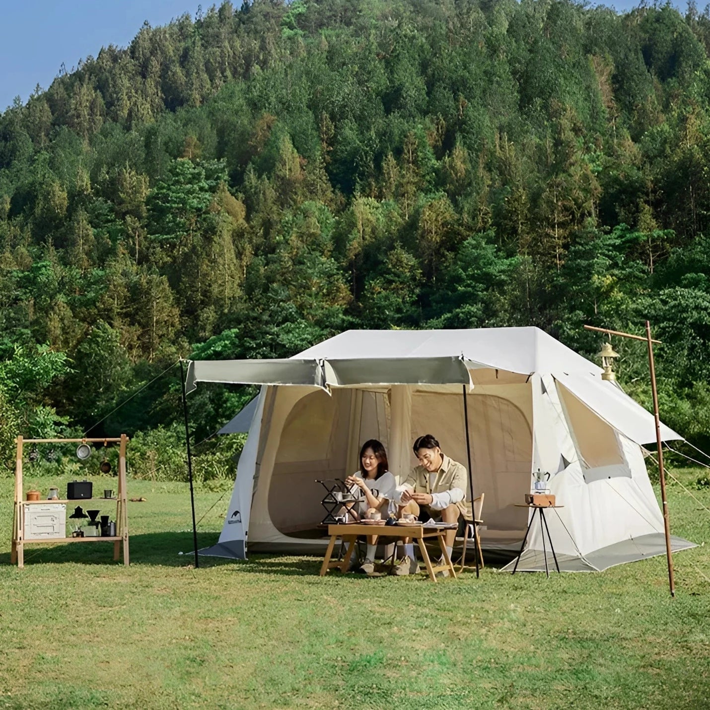 Naturehike large waterproof family camping tent with multiple rooms set up in a natural forested area with trees and clear sky in the background.