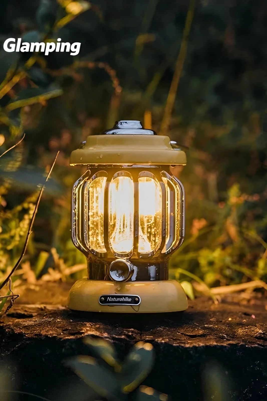 Vintage-style portable LED camping lantern by Naturehike, illuminated outdoors near grass and trees.