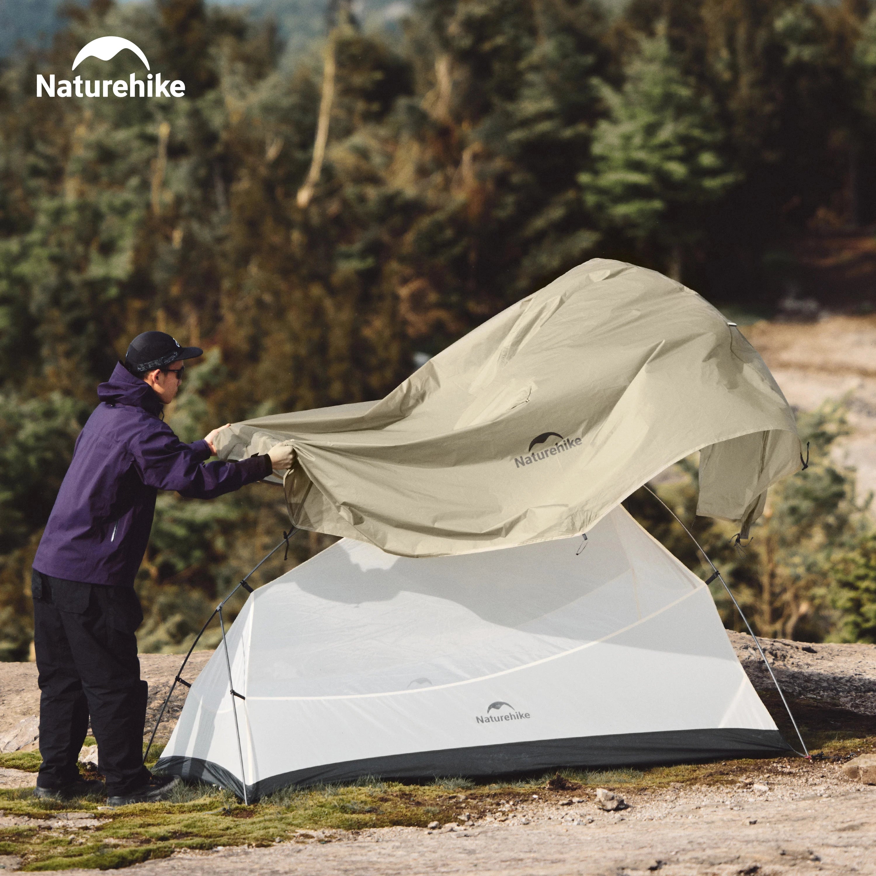 Naturehike Ultralight Waterproof 2-Person Backpacking Tent set up in a grassy, shaded area with trees and plants around, ideal for outdoor recreation and leisure.