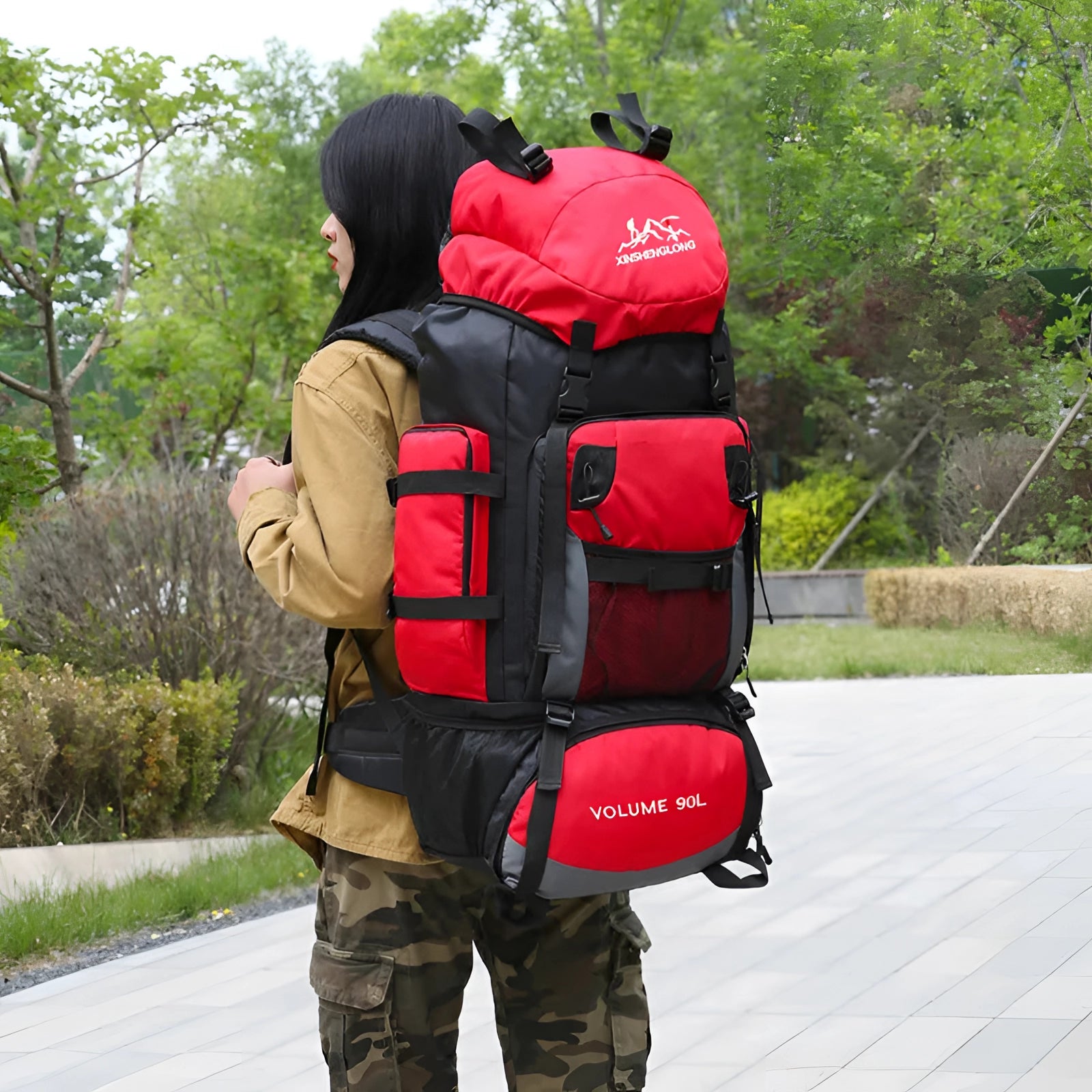 OULYLAN 90L Heavy-Duty Hiking Backpack displayed outdoors, emphasizing its rugged design suitable for travel and recreation.