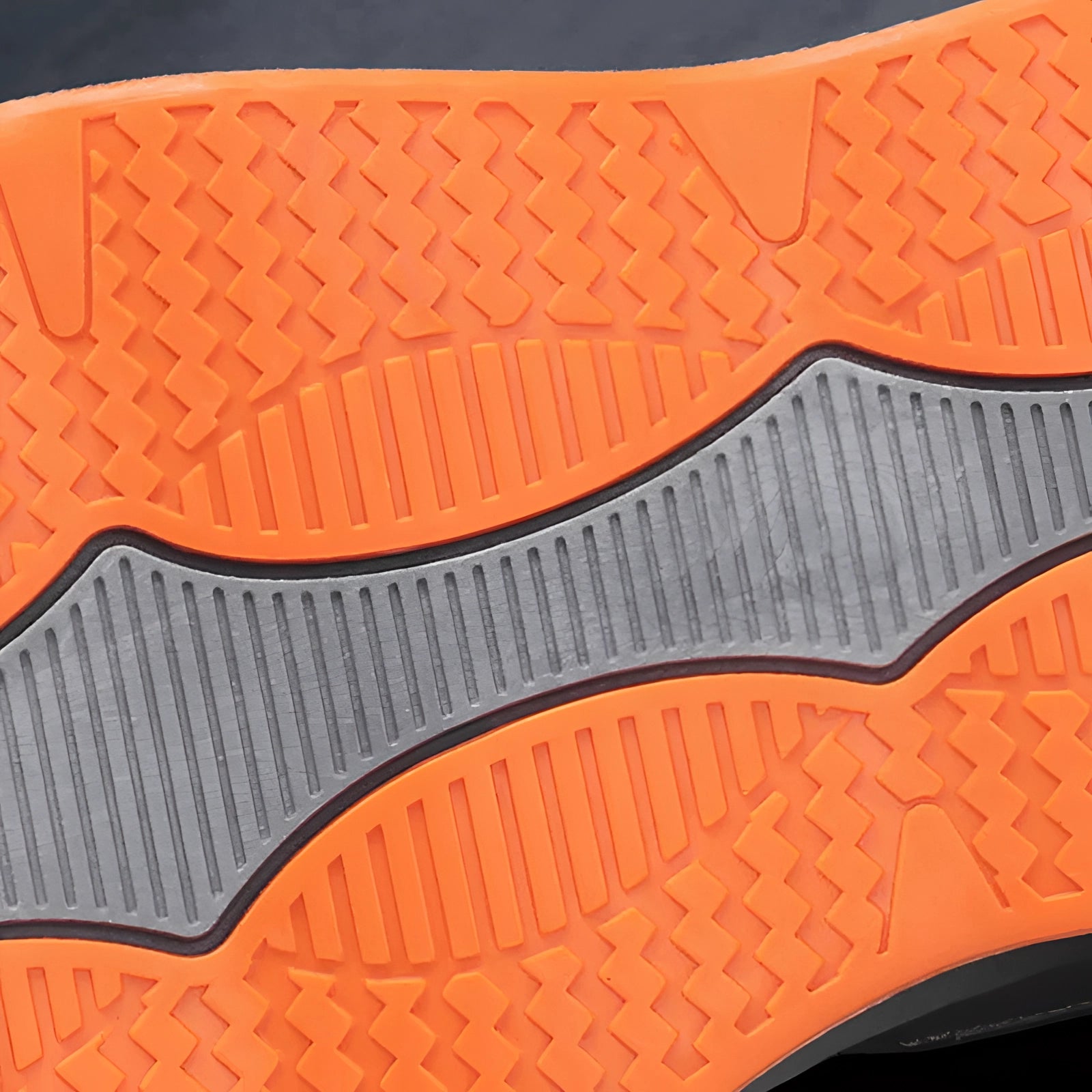 Men's lightweight grey breathable running shoes with cushioned soles, featuring a textile upper and orange accents, resting on a light wood surface.