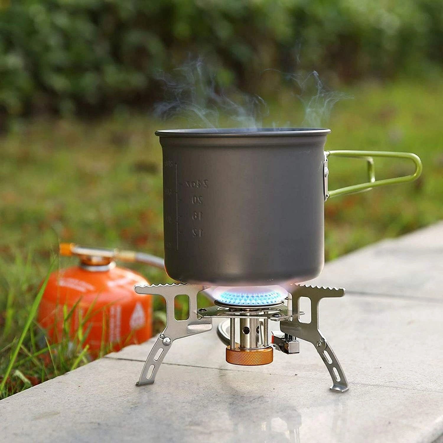 Portable camping stove with a high-efficiency burner, wind-resistant design, and lightweight build, set up for cooking outdoors.