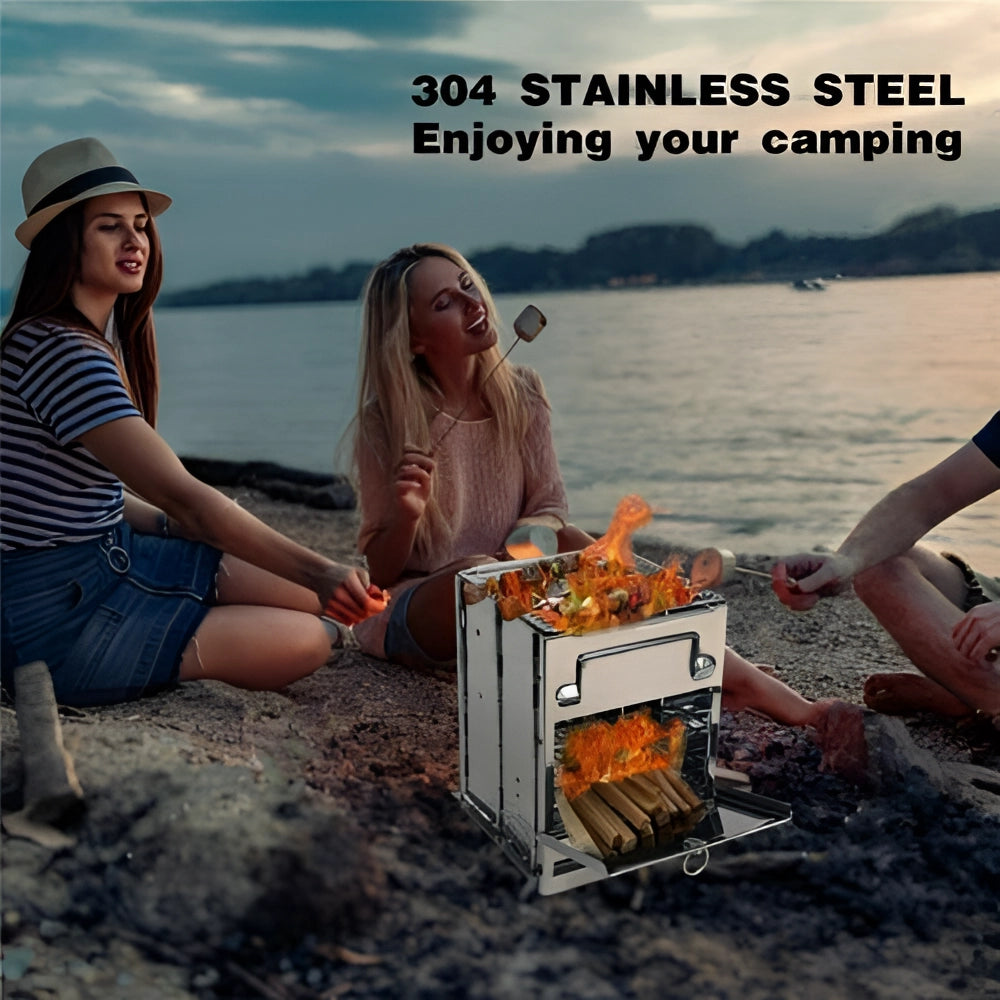 Compact outdoor BBQ grill with stainless steel collapsible wood burning stove setup near a lake under a clear sky.