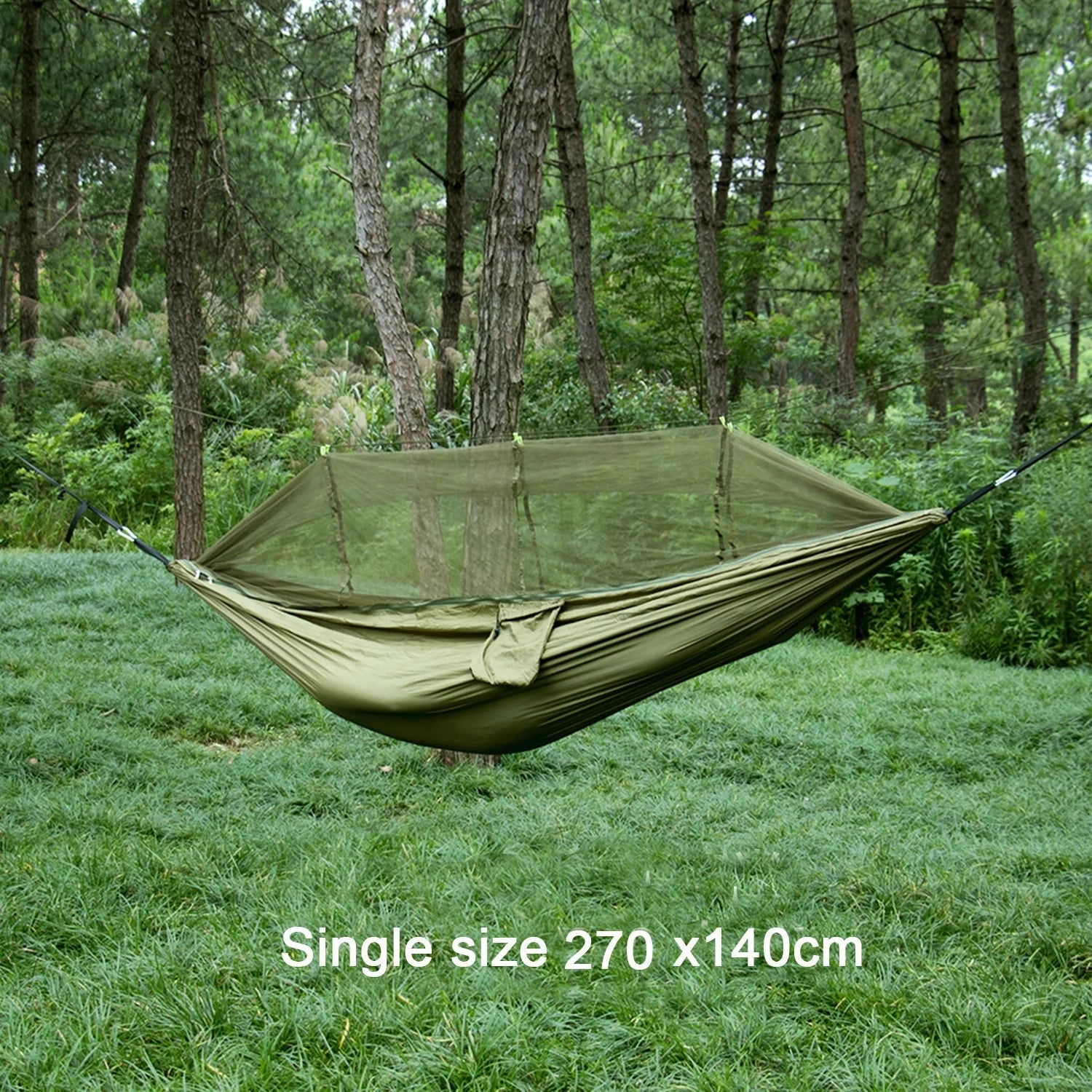 Portable double nylon camping hammock with mosquito net and tree straps set up between two trees in a lush, grassy area.