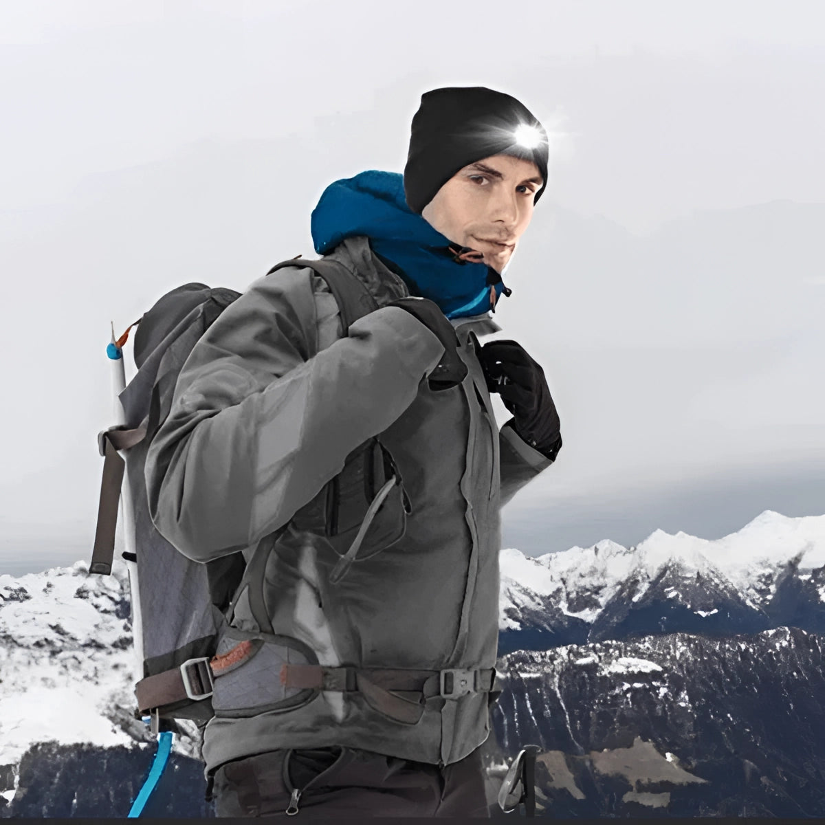 Unisex rechargeable LED beanie hat for outdoor activities, shown in a snowy mountain landscape with clear sky and slopes.