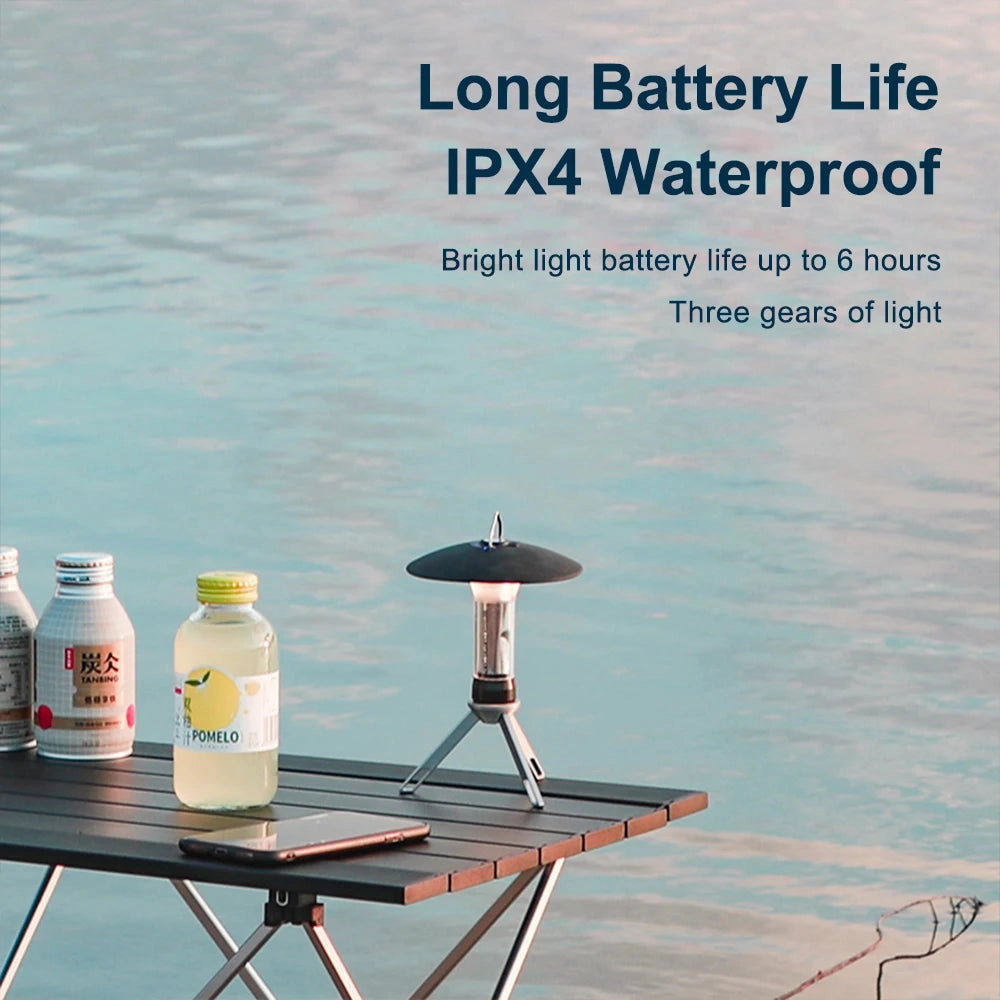 Rechargeable LED Camping Lantern displayed on an outdoor table next to a water bottle.