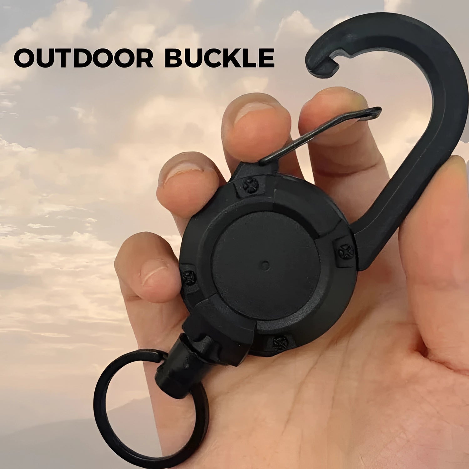 A hand holding durable quick release D-ring clips for tactical backpacks against a cloudy sky.