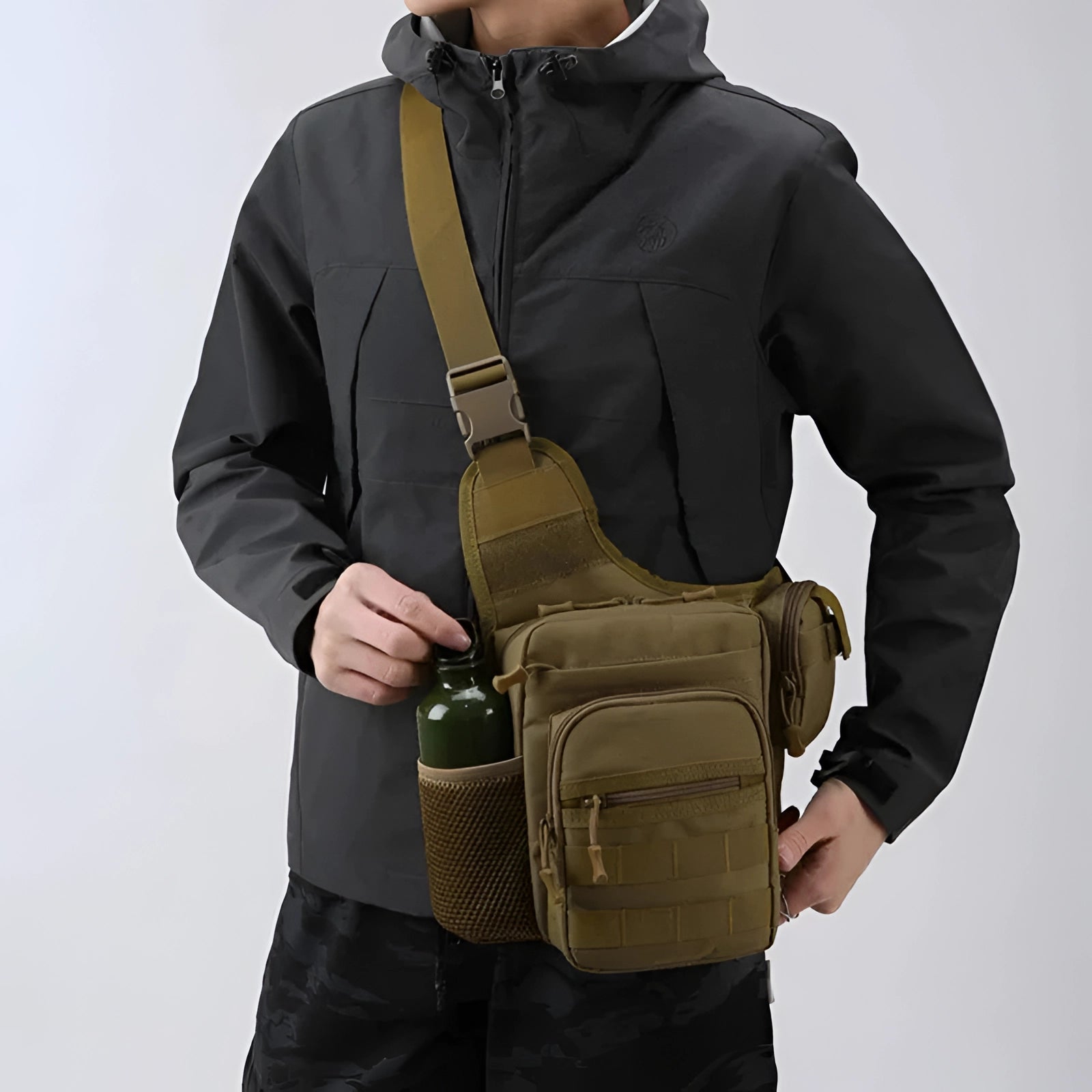 Tactical sling bag in khaki color with a military molle design, featuring a water-resistant outer material, ideal for outdoor travel.