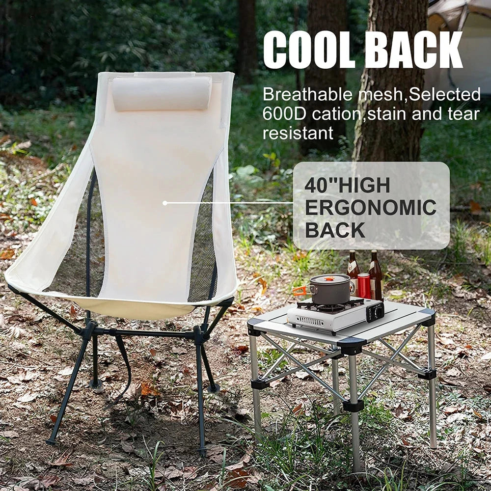 Ultralight foldable mesh camping chair with headrest in a natural outdoor setting with grass and plant life.