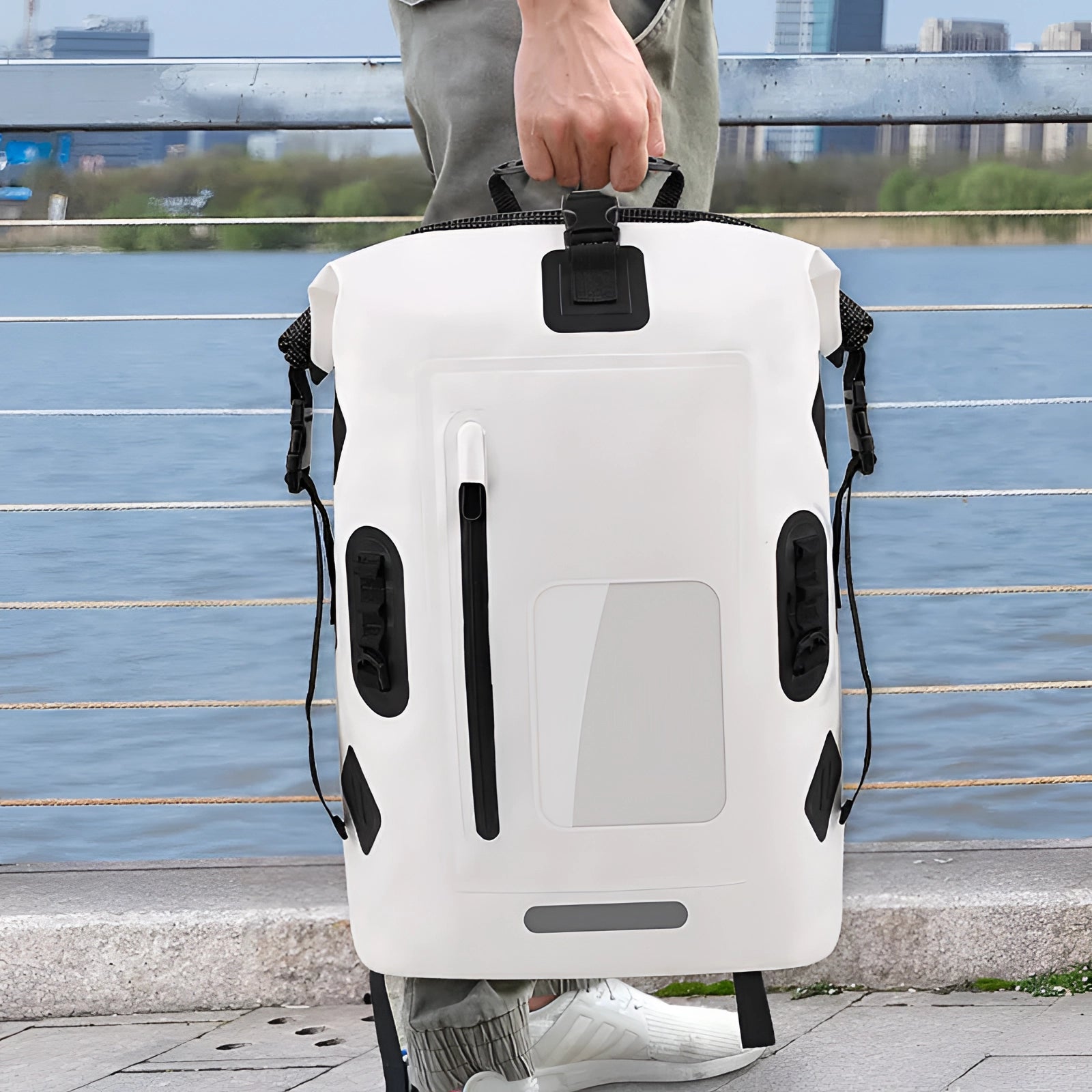 Waterproof hard-shell outdoor adventure backpack with a durable design, displayed on an asphalt surface, showcasing its high-capacity and rugged features.