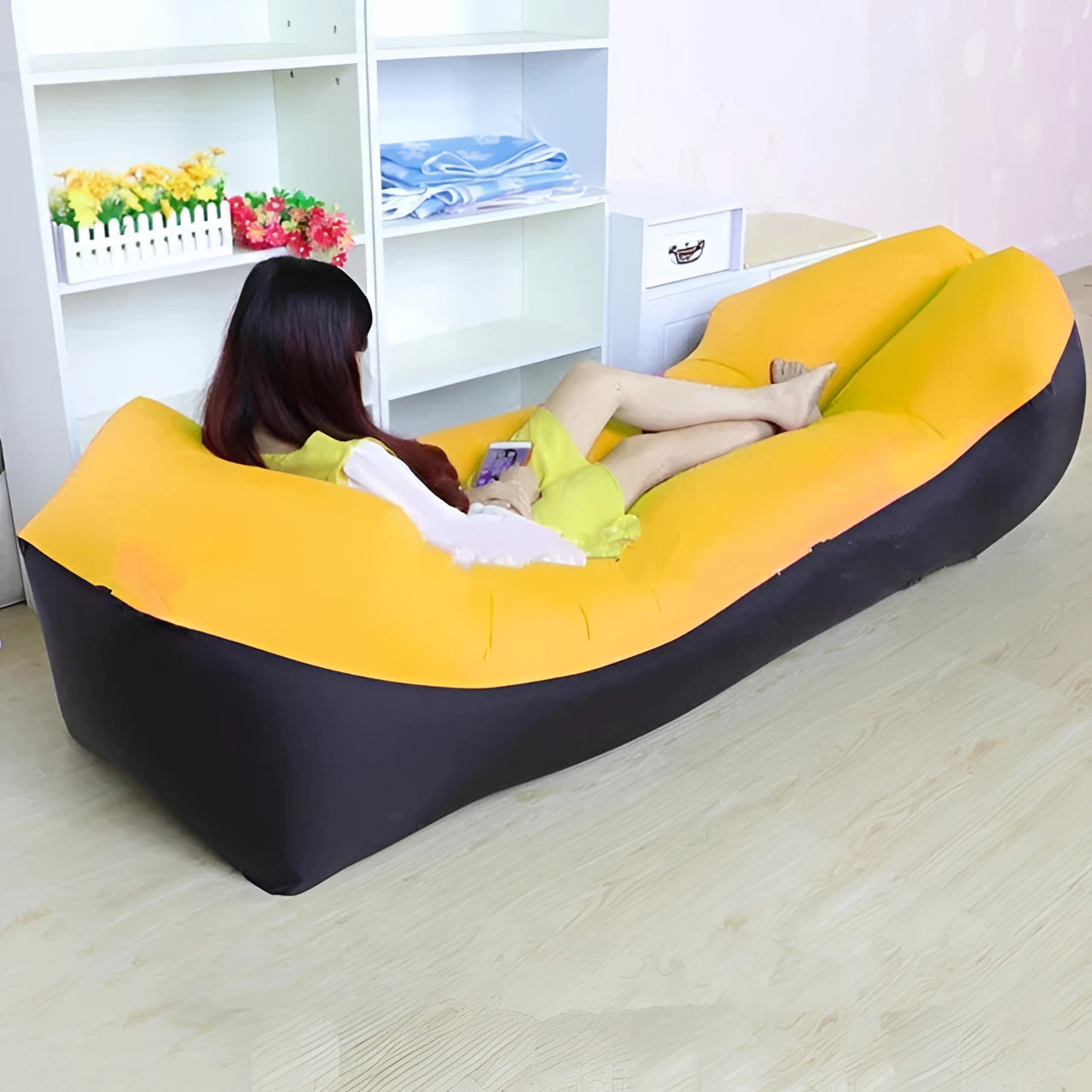 Yellow Waterproof Outdoor Inflatable Sofa, Portable Quick-Inflate Air Couch in a living room setting with hardwood flooring and a shelf in the background.