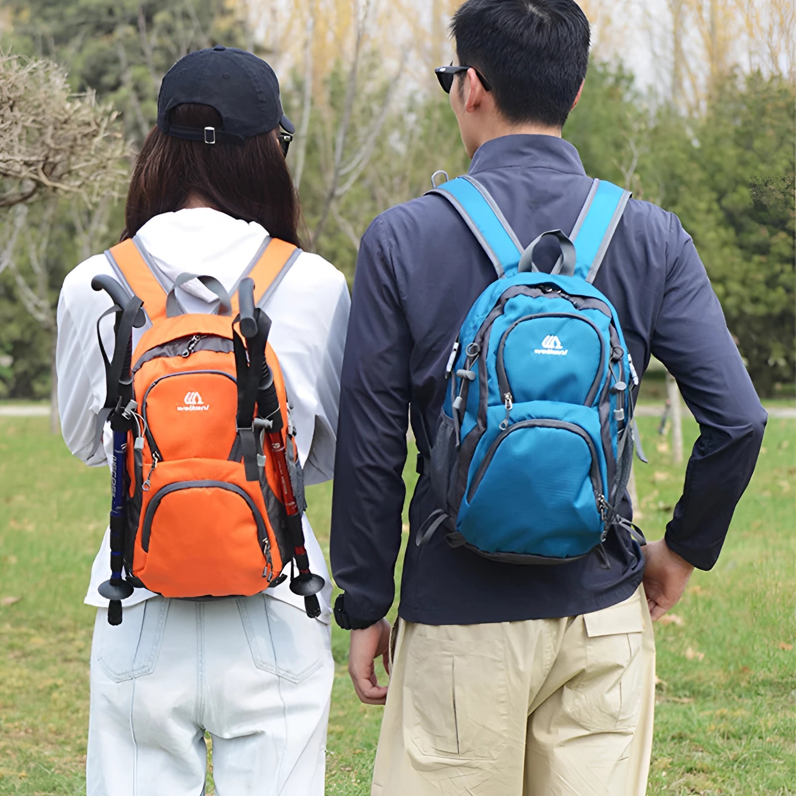 Lightweight water-resistant hiking backpack by Wellsan, featuring an ergonomic design with multiple pockets, displayed in an outdoor setting with greenery in the background.