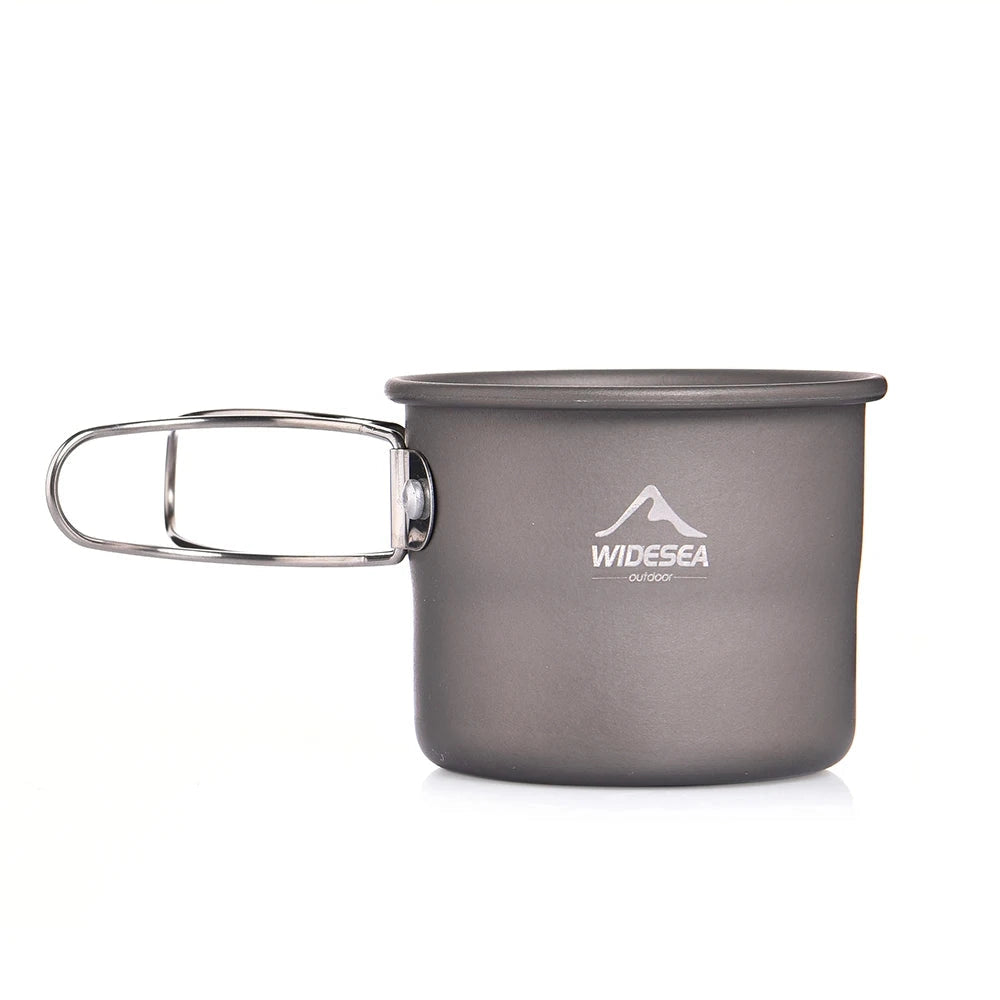 Lightweight titanium camping mug with a sleek metallic finish, ideal for portable outdoor cookware, featuring a sturdy handle and compact design for easy carrying and use in camping settings.